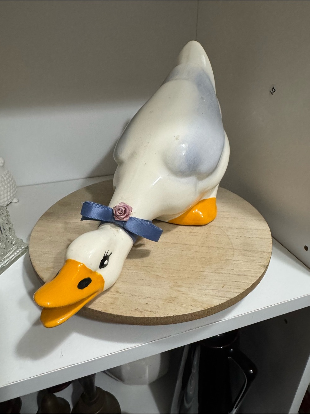 White and Yellow Ceramic Duck Figurine with Blue Ribbon
